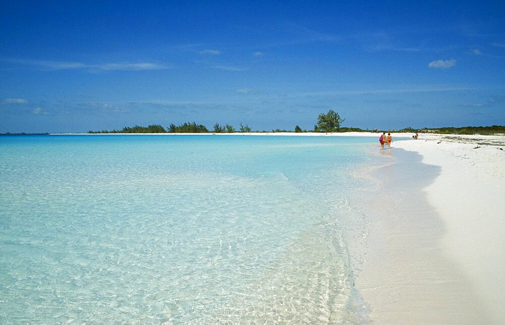 CUBA Isla De Juventud Cayo Largo Playa Sirena with couple of tourists walking by the waters edge