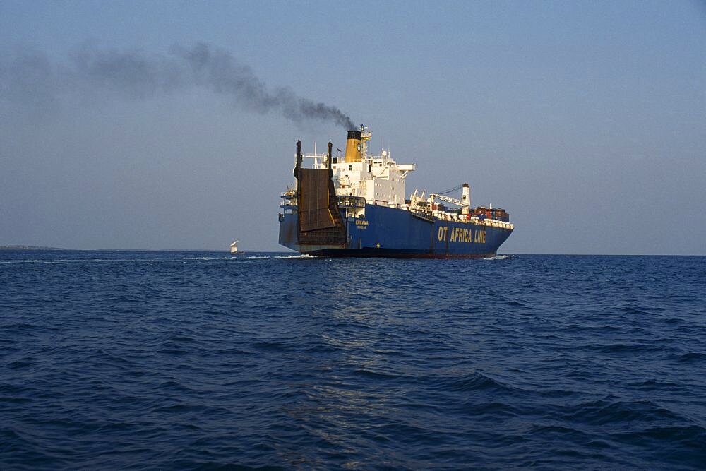 GHANA  Transport Container ship leaving Tema port emitting stream of thick black smoke from central funnel. West Africa   Air pollution  vessel