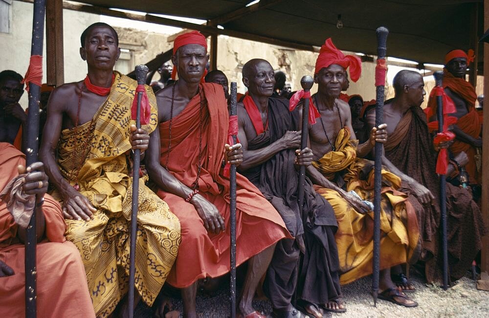 GHANA  Tribal People Ashanti Akan tribal members holding staffs wrapped with red cloth attending funeral.  Red is the colour of mourning.   Asante Color