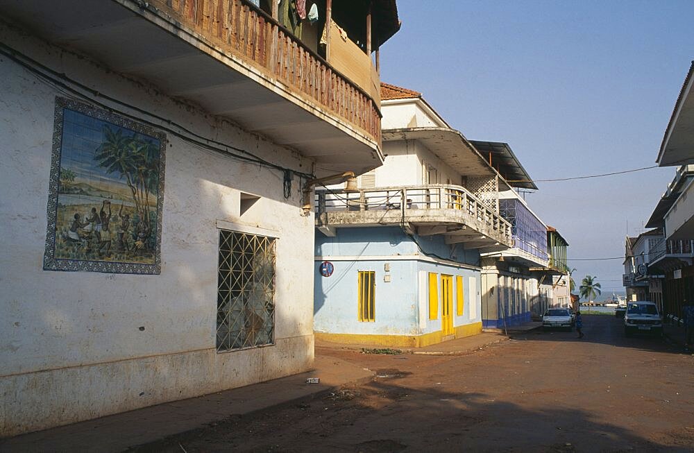 GUINEA BISSAU  Bissau Quiet street in the commercial area with mural painted on exterior wall of building in foreground.