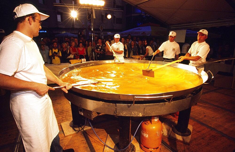 CROATIA Istria Buzet CrBuzet Subotina festival/giant omelette preparation.The highlight of the Buzet Subotina festival held every September  is the preparation of a giant truffle omelette using over two thousand eggs and ten kilos of truffles. The area around Buzet is one of Europes prime locations for finding the gourmet fungus  Croatian cuisine