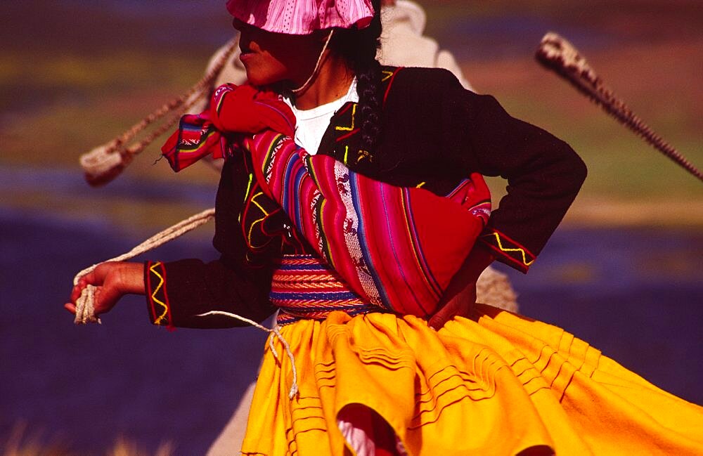 PERU Puno Administrative Department Lake Titicaca Aymara dancer dressed in her traditional costume  an Aymara girl performs a folk dance on the shore of Lake Titicaca Indigenous people