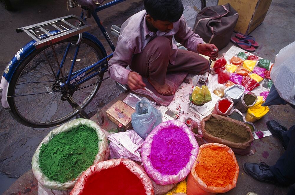 INDIA Delhi Man with brightly coloured powdered paints for use during the Holi Festival. Asia Asian Bharat Colored Inde Indian Intiya Religion Religious Asia Asian Bharat Colored Inde Indian Intiya Religion Religious