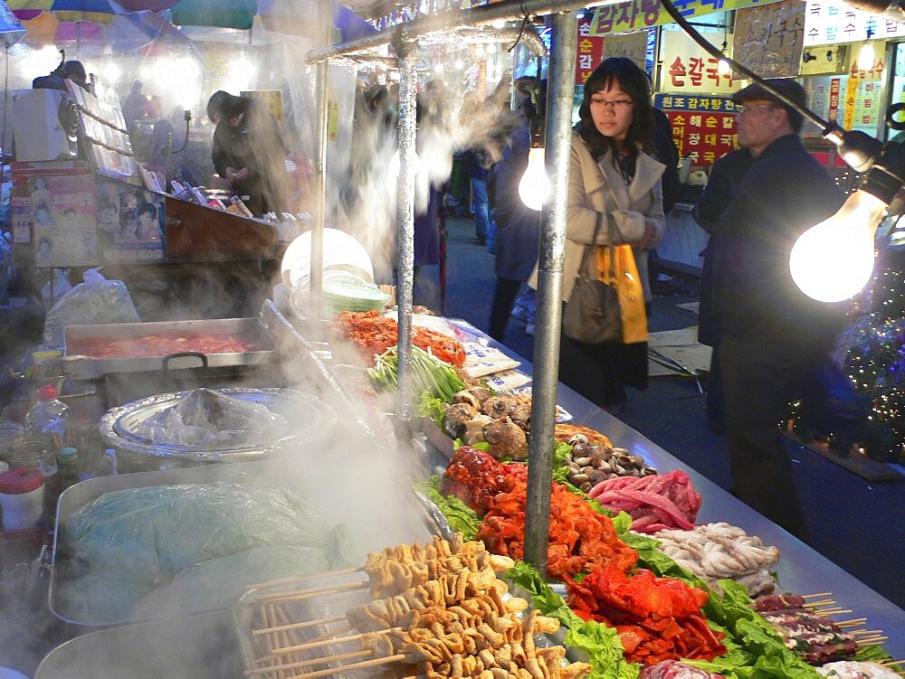 KOREA South Seoul Namdaemun - Namdademun market  December evening  steam rising from food stalls  meat and fish  people walking by Asia Asian Classic Classical Daehanminguk Hanguk Historical Korean Older Tradition Warm Light History