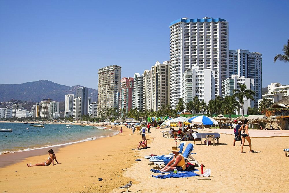 Mexico, Guerrero State Acapulco Condominiums and hotels beside beach  people sunbathing.