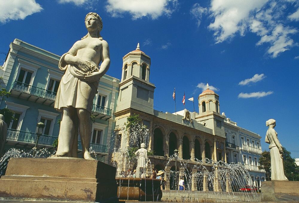 WEST INDIES Puerto Rico San Juan Plaza Des Armas with statues around fountain in front of The Intendencia the former Spanish colonial exchequer