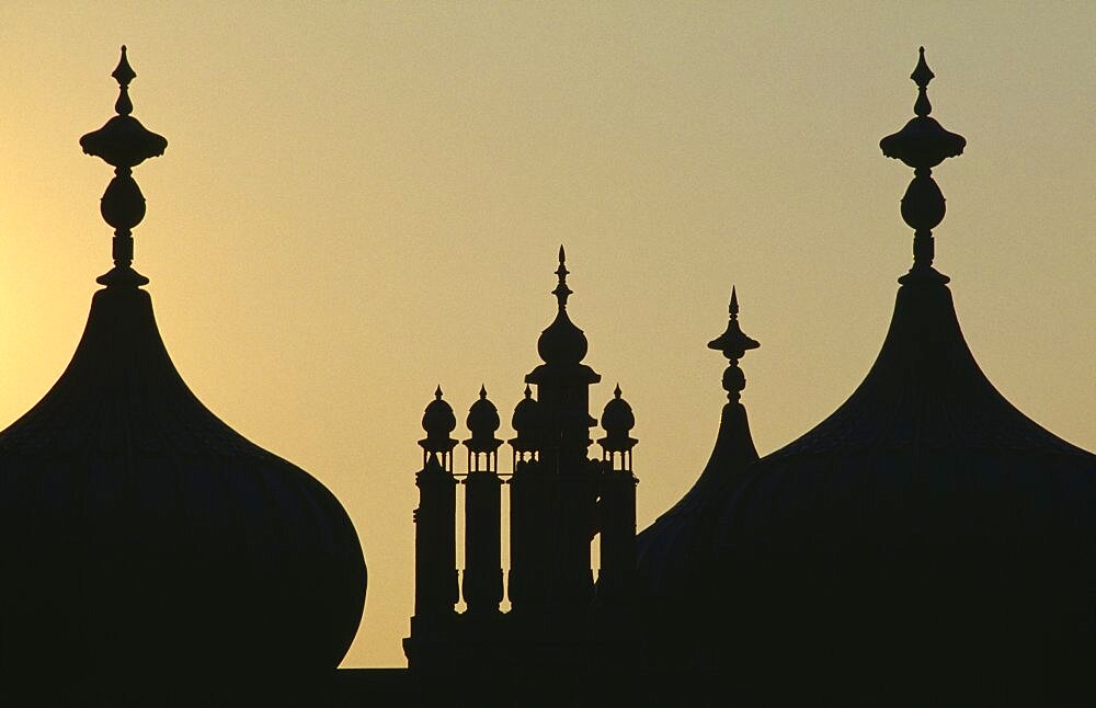 The Royal Pavilion Domes silhouetted at sunset, Brighton, East Sussex, England, United Kingdom