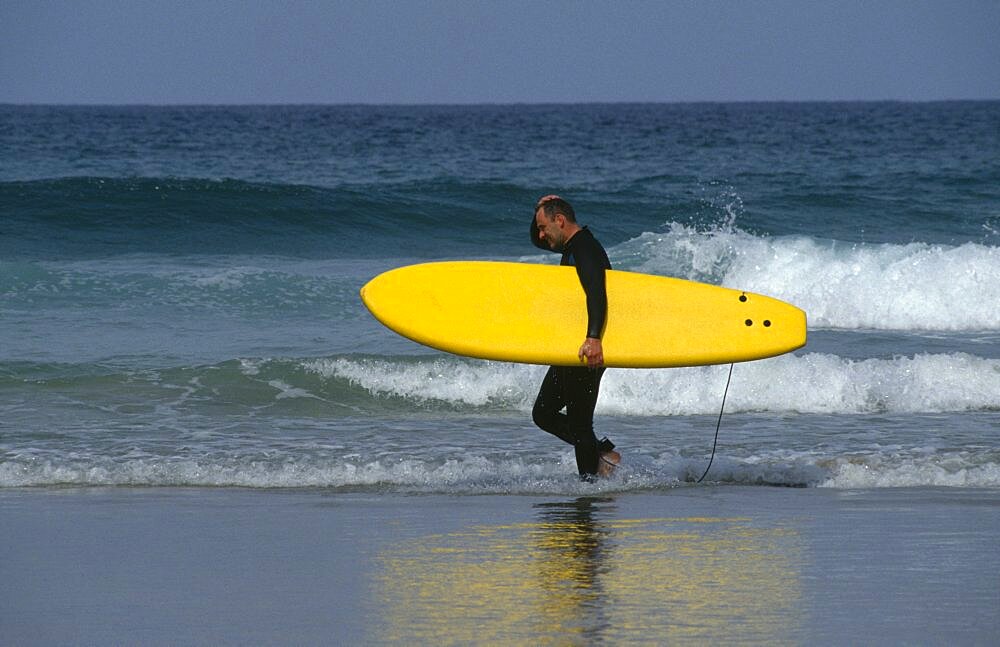 Surfer on Fistral Beach, Newquay, Cornwall, England, United Kingdom