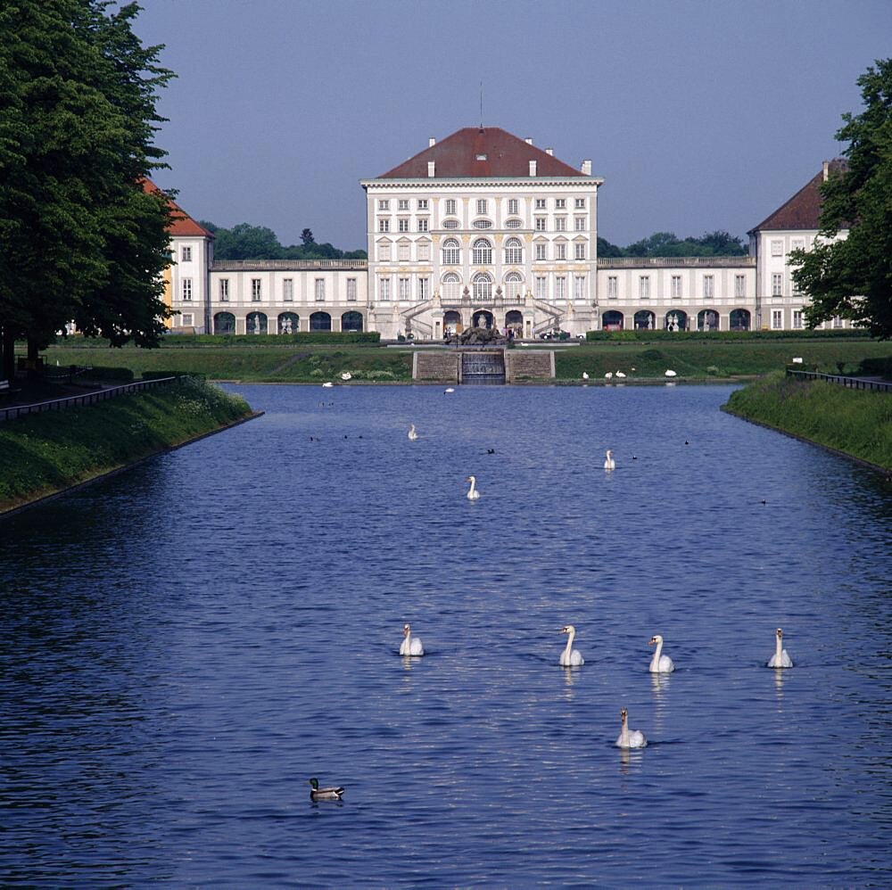 Schloss Nymphenburg, Viewed from tree lined canal with swans and ducks, Munich, Bavaria, Germany