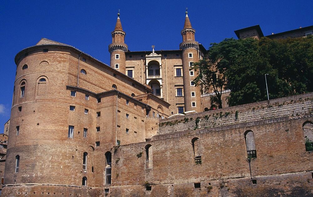 Palazzo Ducale Renaissance palace above the town, Looking up at towers, Urbino, Marche, Italy