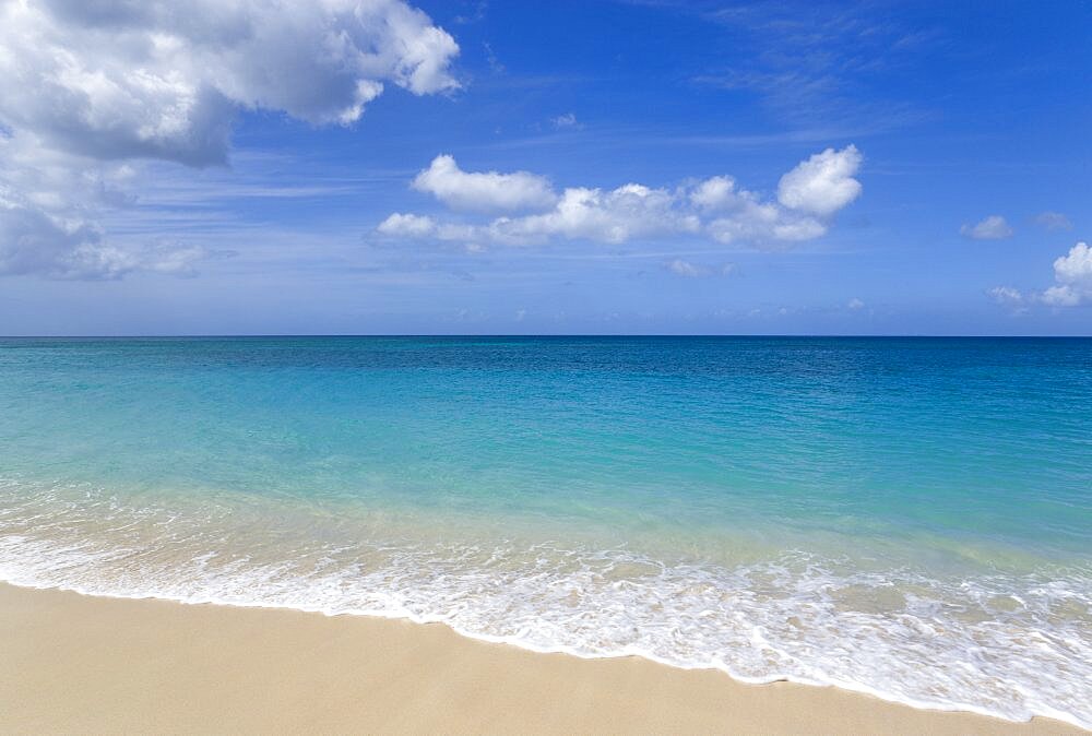 Waves breaking on the shore at Grand Anse Beach with the turquoise sea beyond Beaches Resort, Grenada, West Indies, Caribbean, Central America