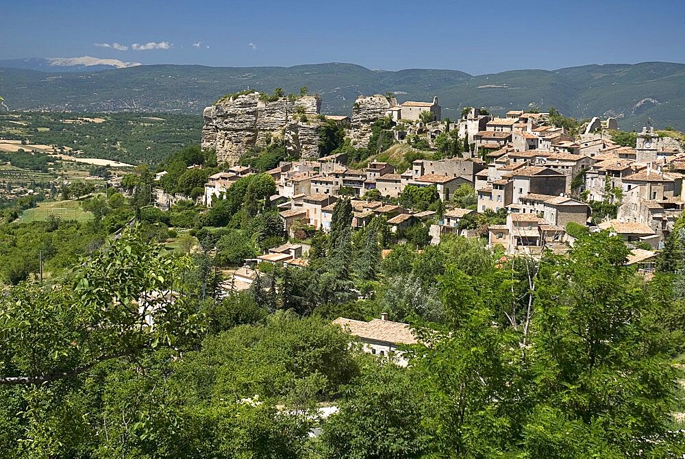 Provencal hilltop village with Mont Ventoux seen in the distance top left, Saignon, Provence, France, Europe