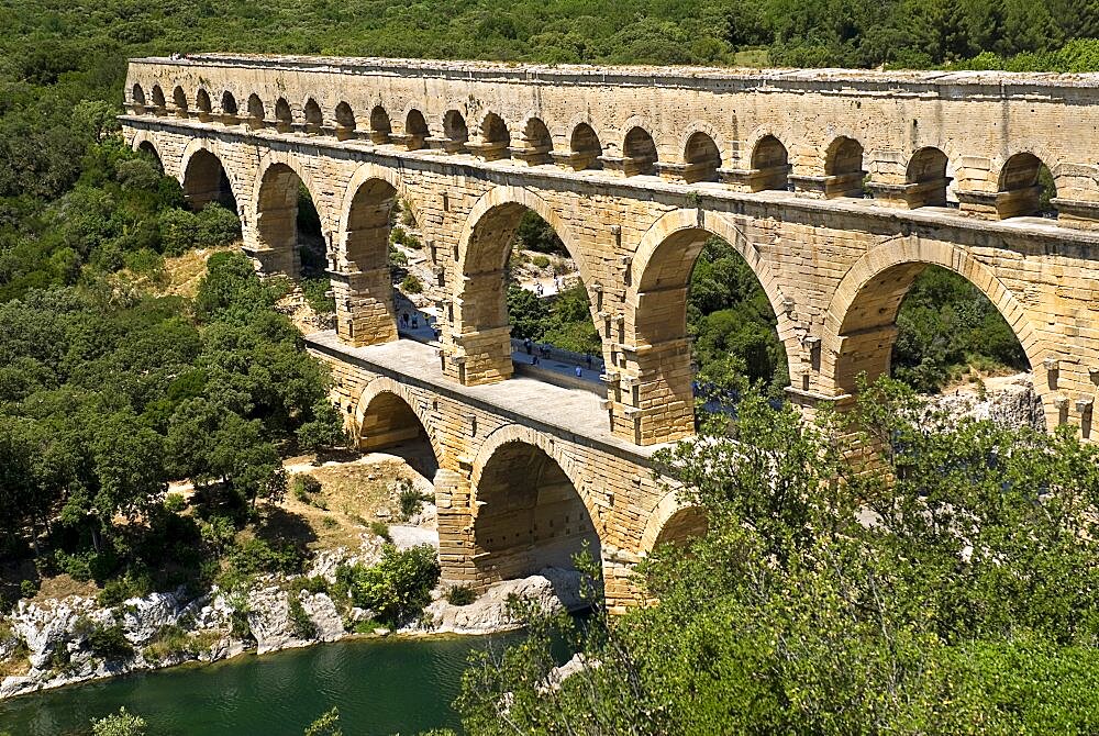 Roman aqueduct from high vantage point on the western side showing three tiers of continuous arches spanning river, Pont du Gard, Languedoc-Roussillon, UNESCO World Heritage Site, France, Europe