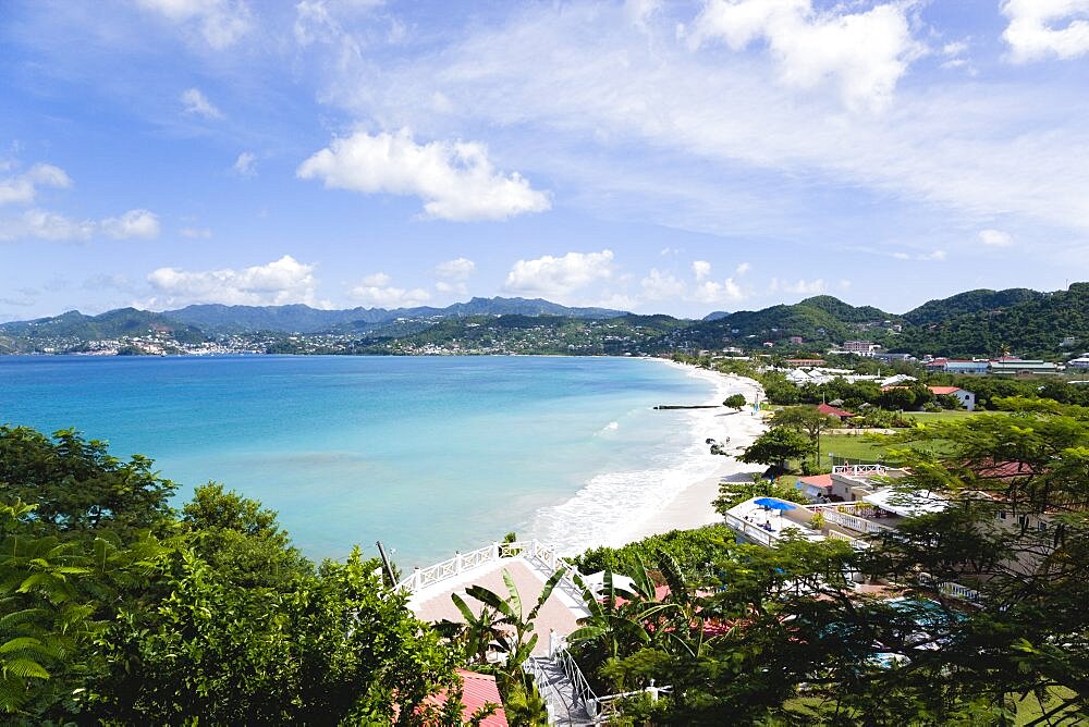 Aquamarine sea and the two mile stretch of the white sand of Grand Anse Beach with St. Georges in the distance, Grenada, West Indies, Caribbean, Central America