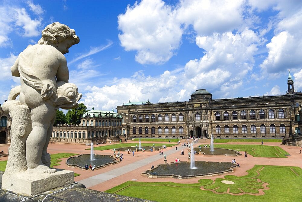 GERMANY, Saxony, Dresden, The central Courtyard and Picture Gallery of the restored Baroque Zwinger Palace gardens busy with tourists seen from the statue lined Rampart originally built between 1710 and 1732 after a design by Matth?us Daniel P?ppelmann in collaboration with sculptor Balthasar Permoser