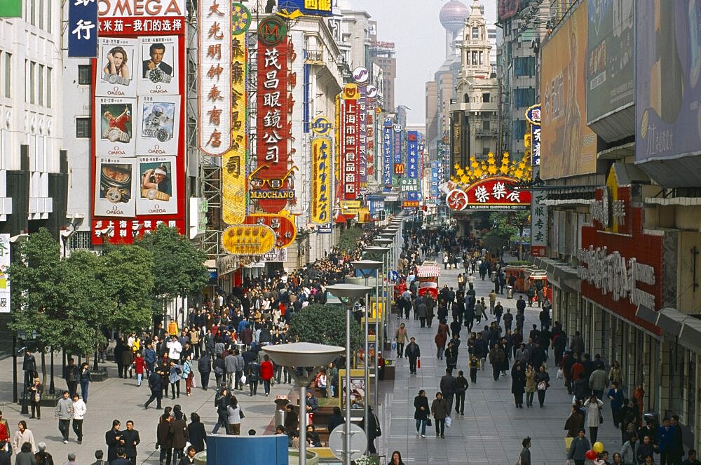 CHINA  Shanghai Pedestrianised street crowded with shoppers and lined with advertising hoardings and neon signs.    Nanjing Road.