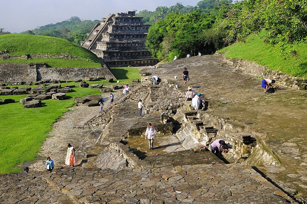 El Tajin archaeological site Archaeologists at work at Tajin Chico with Pyramide de lo Nichos beyond, Papantla, Veracruz, Mexico