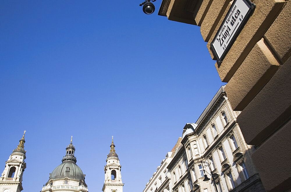 Hungary, Budapest, St Stephen's Basilica with Street sign and facades in central Pest.