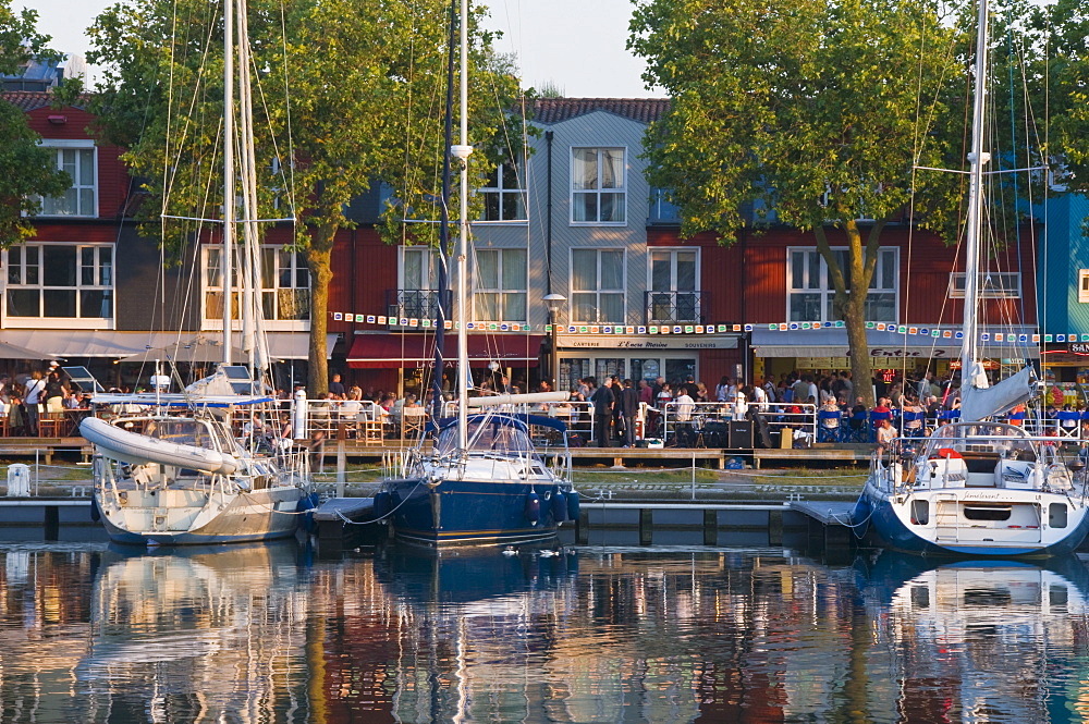 Open-air restaurants overlooking yachts moored in the ancient harbour at La Rochelle, Charente-Maritime, France, Europe