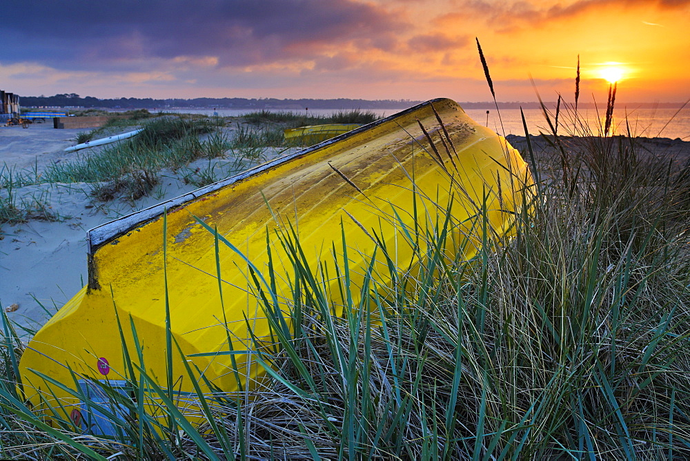 Upturned boat among the sand dunes at Mudeford Spit, Dorset, England, United Kingdom, Europe