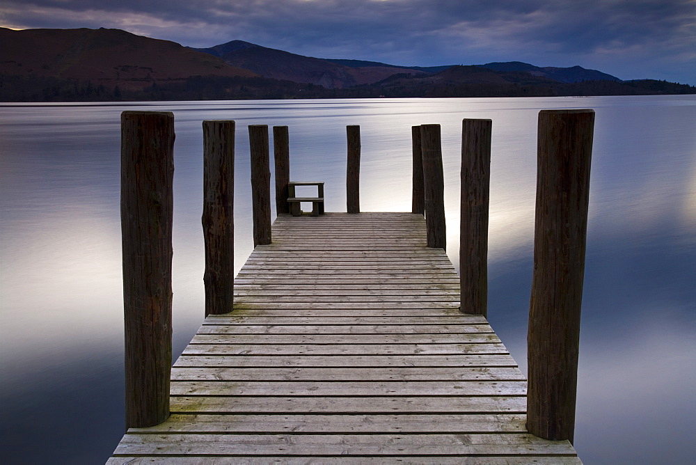 A wooden jetty stretches out into Derwent Water, Lake District National Park, Cumbria, England, United Kingdom, Europe