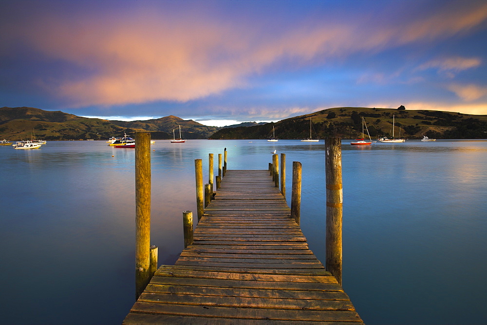 Early morning beside a jetty overlooking Akaroa harbour, Canterbury, South Island, New Zealand, Pacific