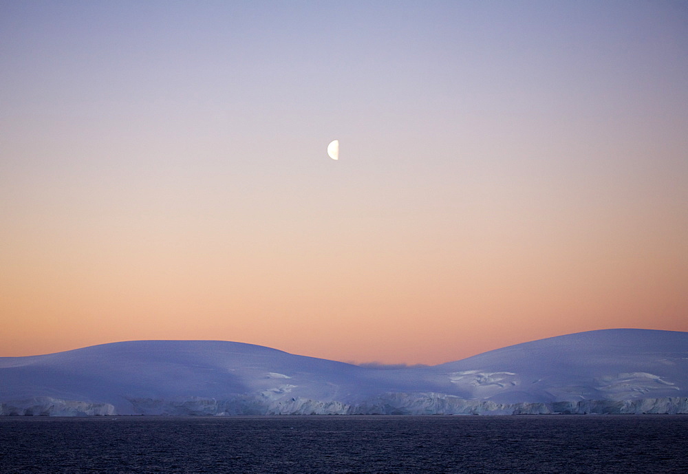 Midnight moon over the Antarctic Peninsula, Antarctica, Polar Regions