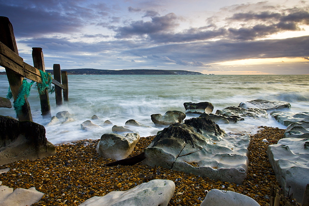 Sea defences at Hurst Spit, looking across to the Isle of Wight and the Needles, Hampshire, England, United Kingdom, Europe