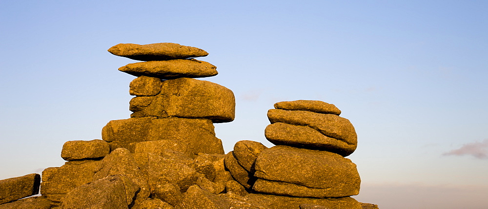 Late afternoon sunlight glows on the granite rock formations of Great Staple Tor in Dartmoor National Park, Devon, England, United Kingdom, Europe