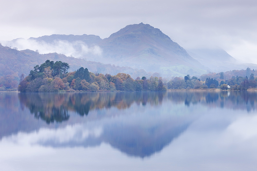 Mist hangs over the lake and island at Grasmere with Helm Crag beyond, Lake District, Cumbria, England, United Kingdom, Europe