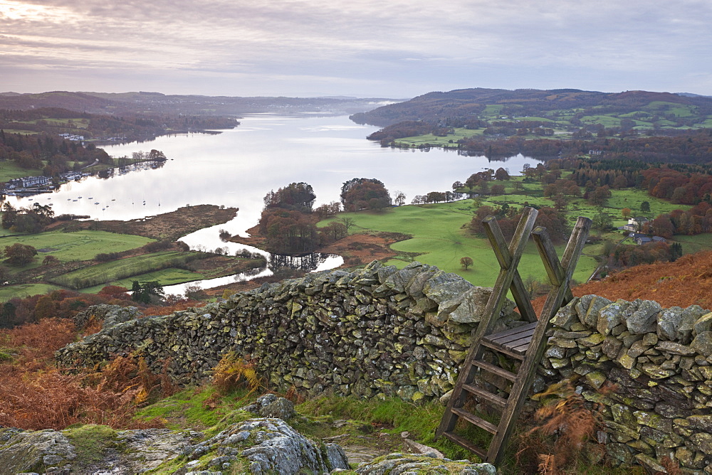 Dry stone wall and wooden stile above Lake Windermere, Lake District National Park, Cumbria, England, United Kingdom, Europe