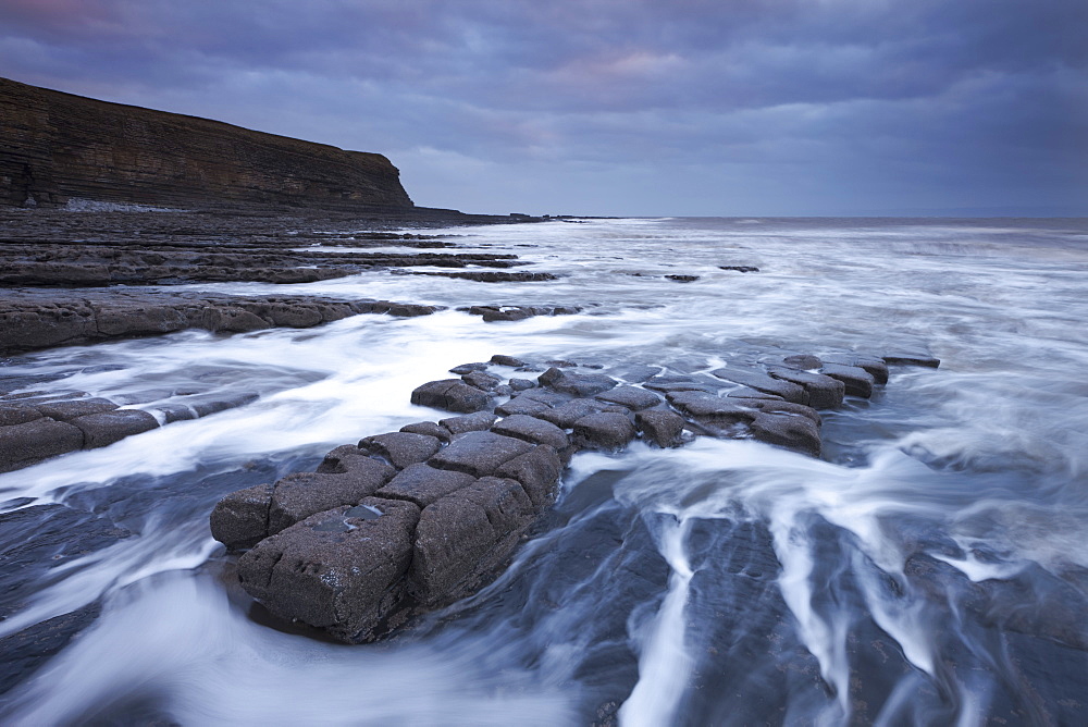 Waves rushing around broken ledges at Nash Point on the Glamorgan Heritage Coast, Wales, United Kingdom, Europe