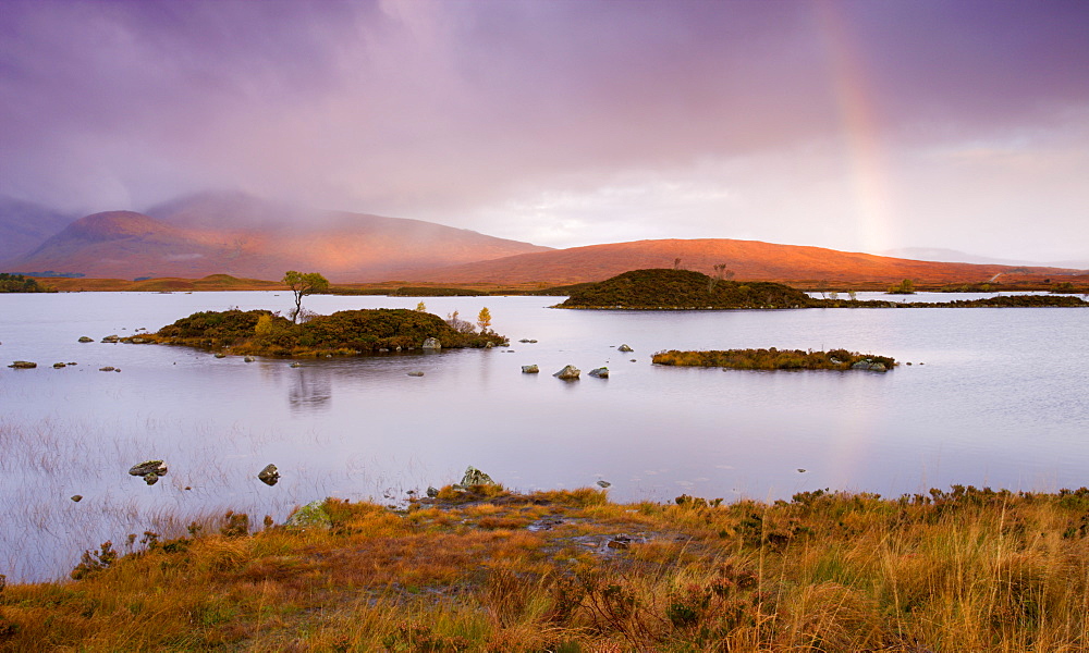 Rainbow in stormy skies over Lochan Na H-Achlaise on Rannoch Moor in Autumn, Highlands, Scotland, United Kingdom, Europe