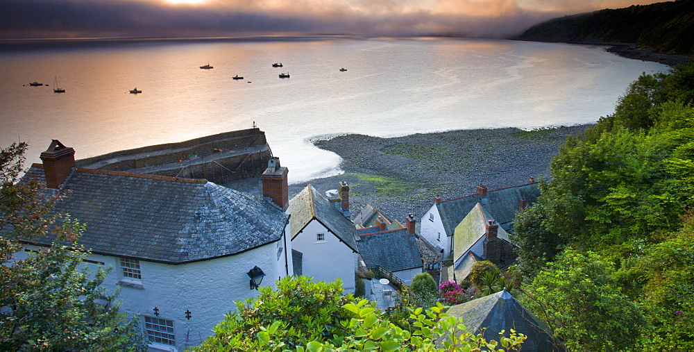 Fog obscures the summer sunrise at Clovelly in Devon, England, United Kingdom, Europe