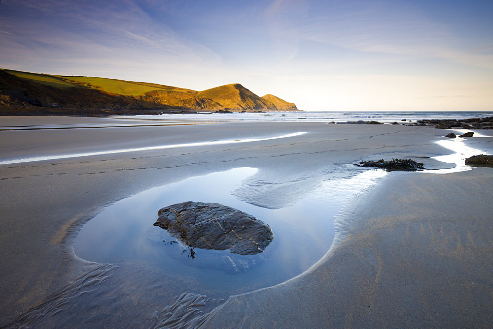 Exposed rockpool at low tide on a deserted beach at Crackington Haven, Cornwall, England, United Kingdom, Europe