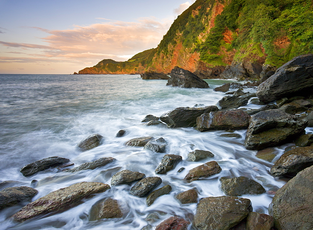 Waves crash around the rocky shores of Woody Bay at high tide, Exmoor National Park, Devon, England, United Kingdom, Europe