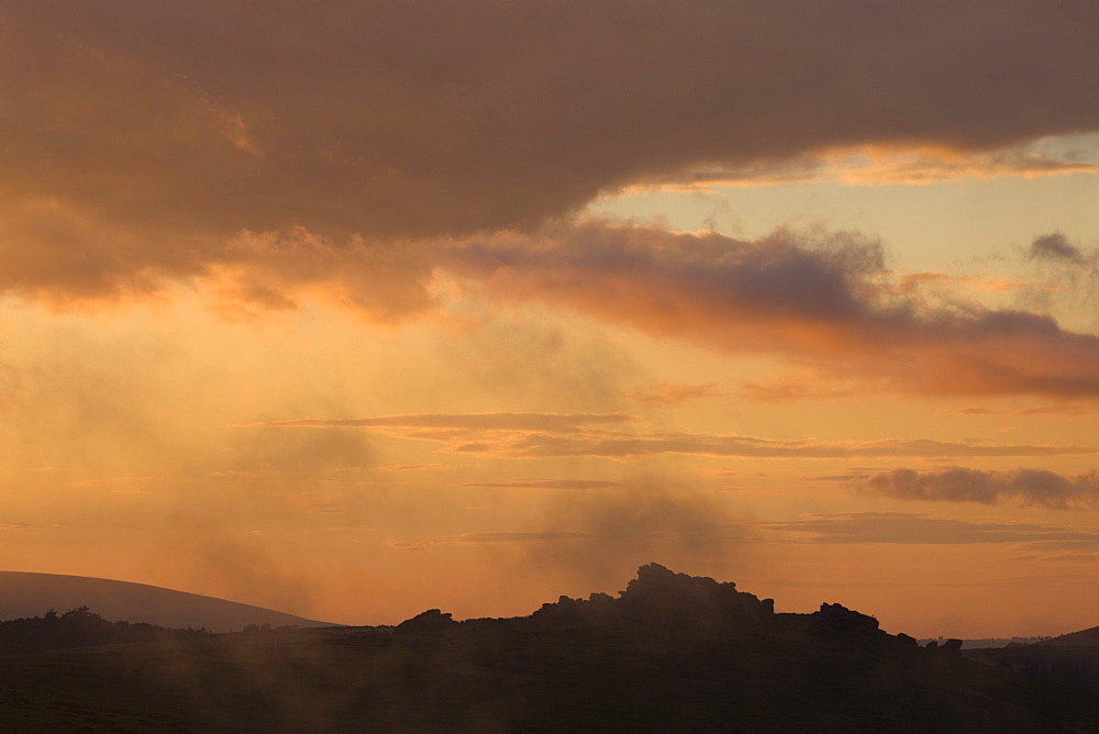 Silhouetted Hound Tor at sunset, Dartmoor National Park, Devon, England, United Kingdom, Europe