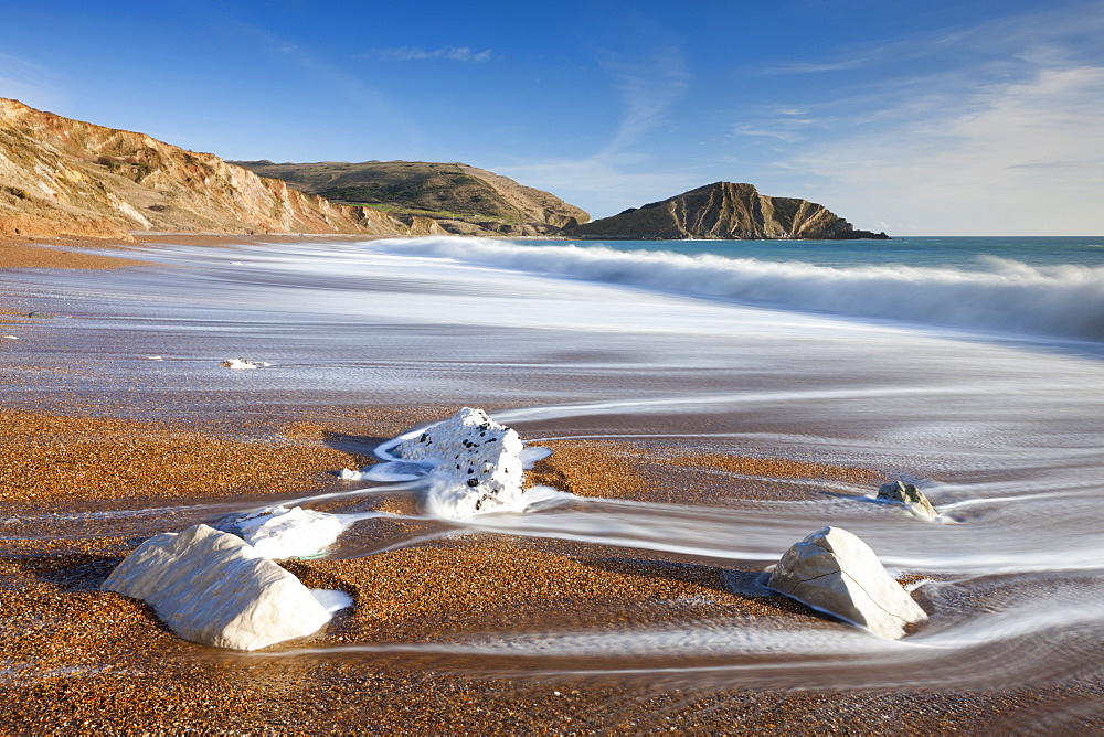 Waves wash clean the beautiful beach at Worbarrow Bay on the Jurassic Coast, UNESCO World Heritage Site, Dorset, England, United Kingdom, Europe