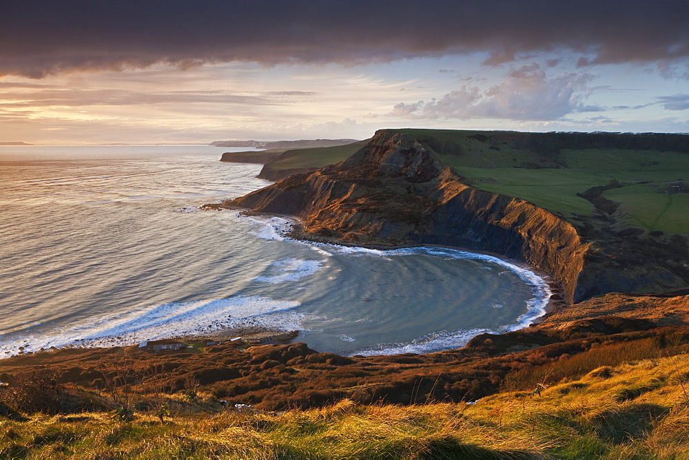 Storm light illuminates Chapmans Pool and Houns Tout cliff, viewed from St. Aldhelm's Head, Jurassic Coast, UNESCO World Heritage Site, Dorset, England, United Kingdom, Europe