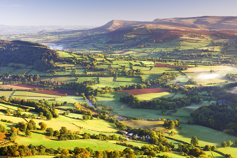 Morning sunshines illuminates the patchwork fields in the Usk Valley, looking towards the Black Mountains, Brecon Beacons, Wales, United Kingdom, Europe