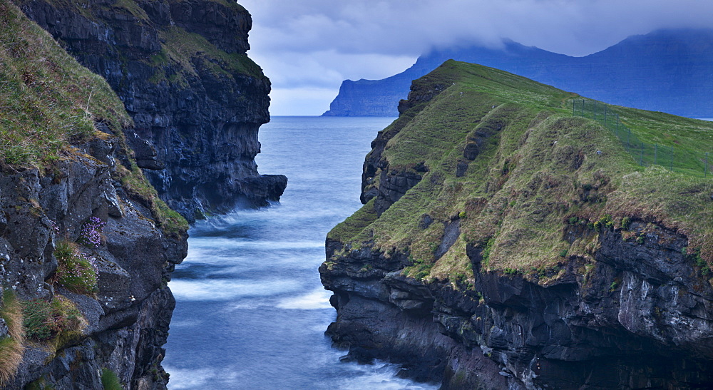 Dramatic coastline at Gjogv on the island of Eysturoy, Faroe Islands, Denmark, Europe