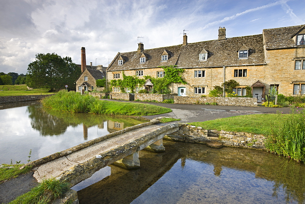 Stone footbridge and cottages at Lower Slaughter in the Cotswolds, Gloucestershire, England, United Kingdom, Europe 