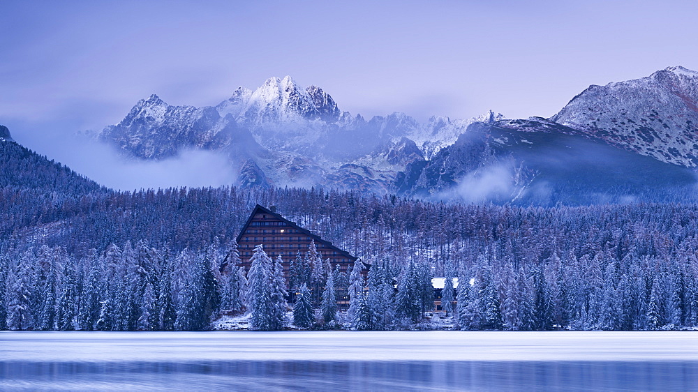 Strbske Pleso lake and mountains in winter snowfall, High Tatras, Slovakia, Europe 