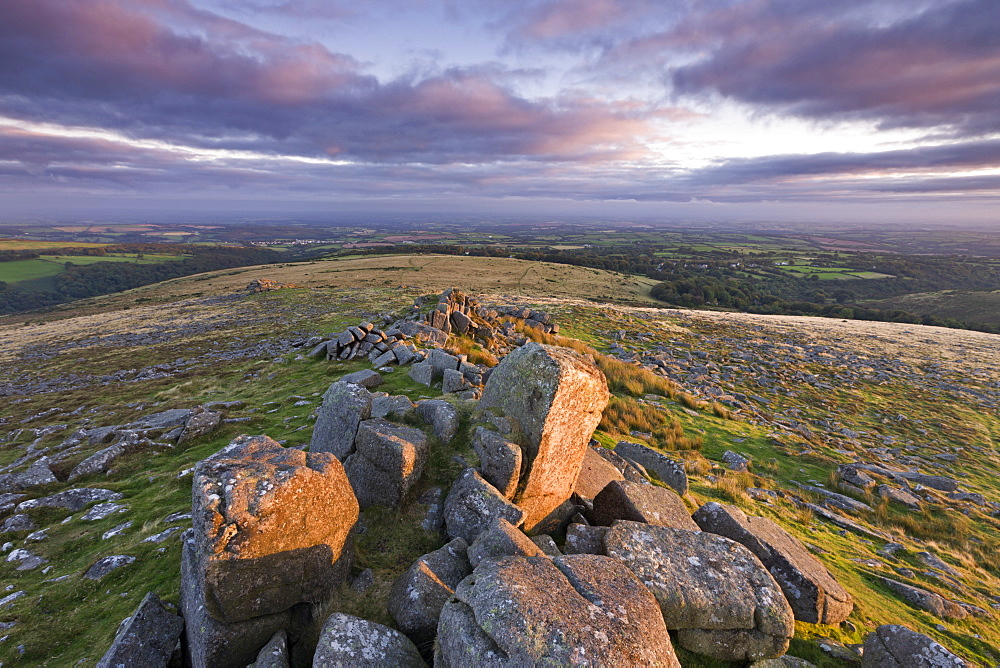 Early morning sunlight lights up the granite rocks of Belstone Tor, Dartmoor National Park, Devon, England, United Kingdom, Europe