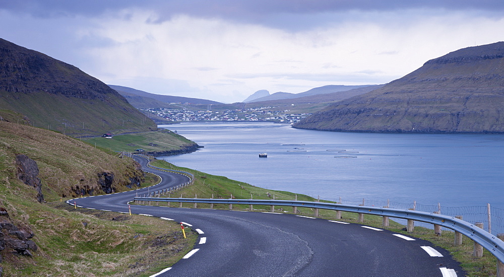 Winding coastal road leading to Sorvagur on the island of Vagar, Faroe Islands, Denmark, Europe 