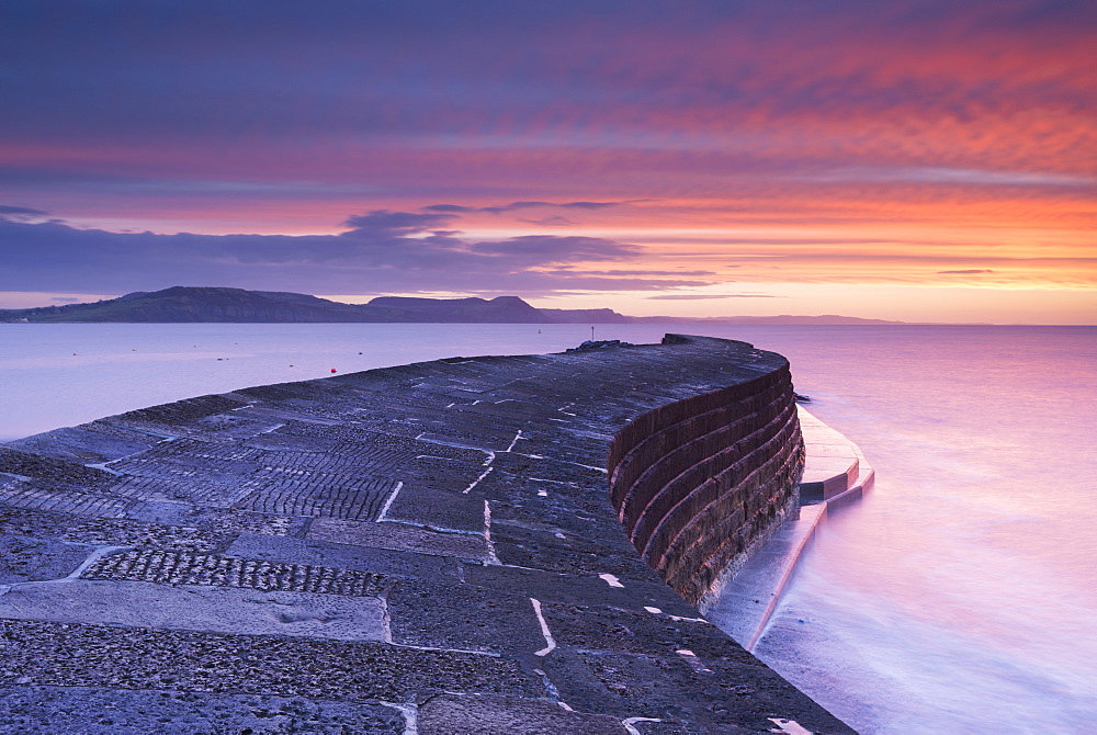 Sunrise in winter over the Jurassic Coast, UNESCO World Heritage Site, from The Cobb, Lyme Regis, Dorset, England, United Kingdom, Europe 