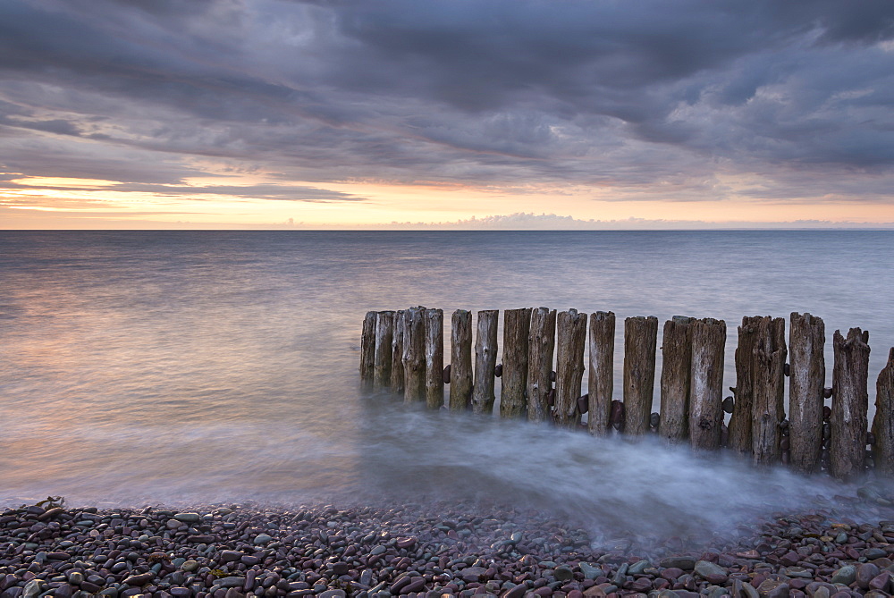 Wooden groyne on Bossington Beach at sunset, Exmoor, Somerset, England, United Kingdom, Europe