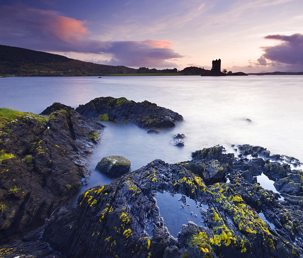 Twilight on the shores of Loch Linnhe near Appin, looking out towards the silhouette of Castle Stalker, Highlands, Scotland, United Kingdom, Europe