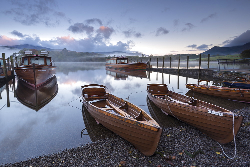 Boats moored on Derwent Water at dawn in autumn, Keswick, Lake District, Cumbria, England, United Kingdom, Europe