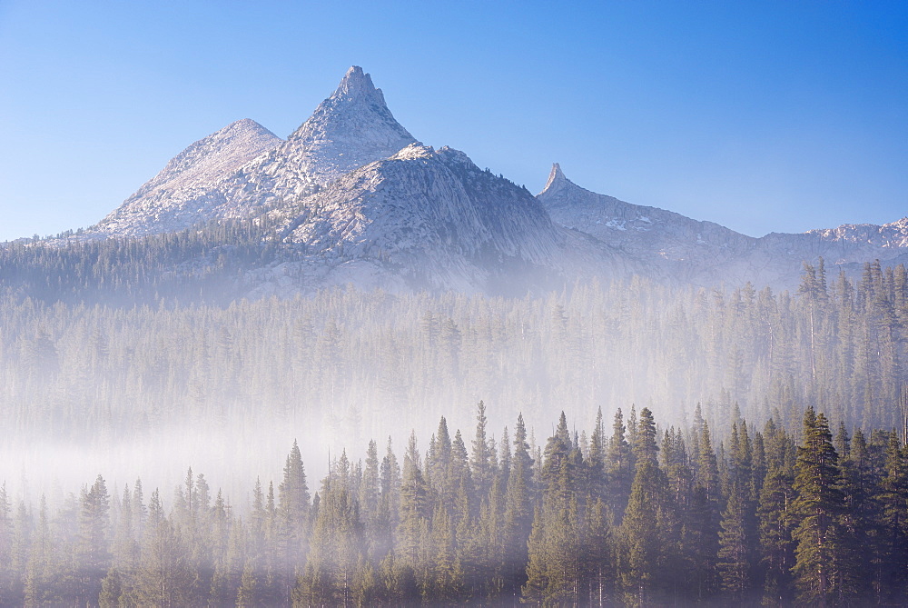 Unicorn Peak rising above a mist shrouded forest, Yosemite National Park, UNESCO World Heritage Site, California, United States of America, North America